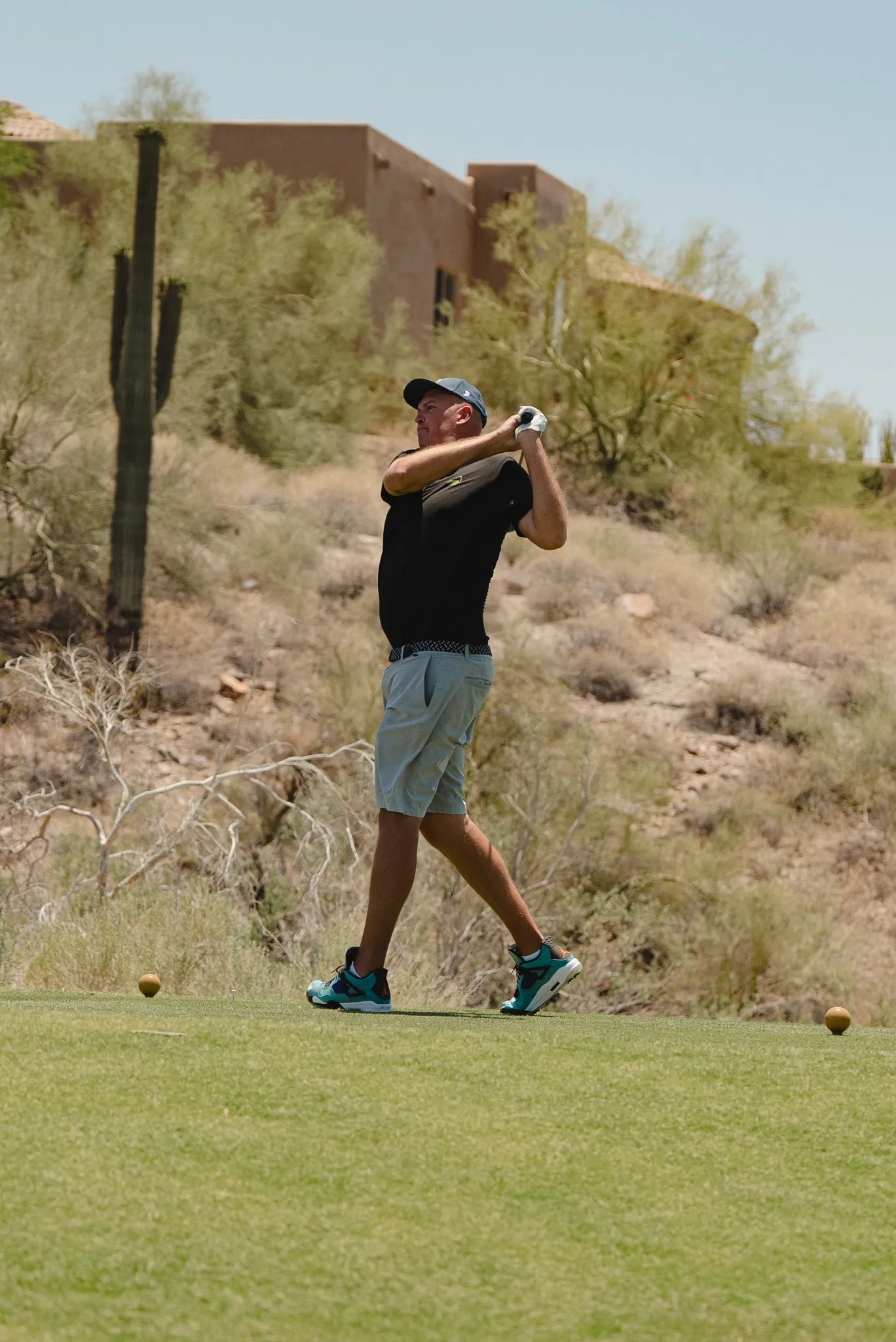 Golfer teeing off in the desert